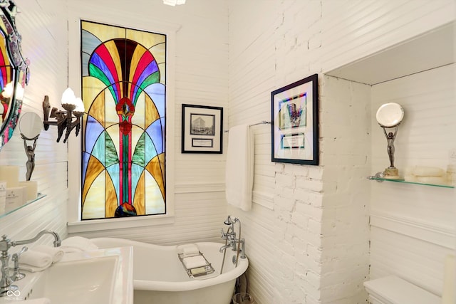 bathroom with a freestanding bath and a sink