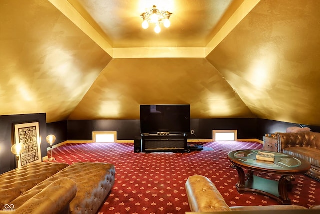 carpeted cinema featuring lofted ceiling