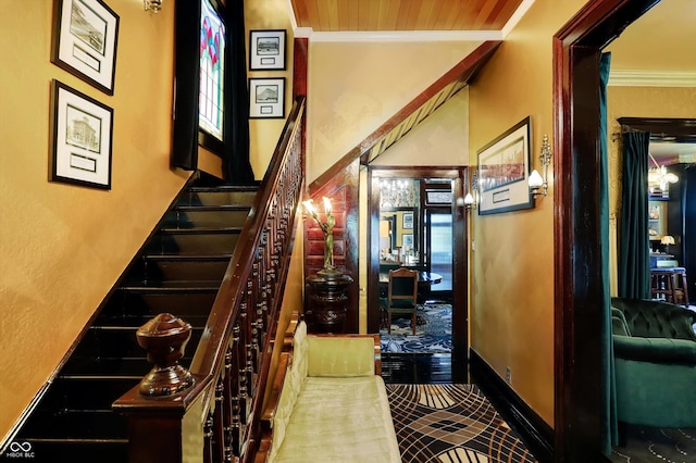 staircase with baseboards and ornamental molding