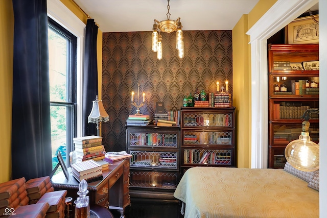 bedroom featuring a chandelier, multiple windows, and wallpapered walls