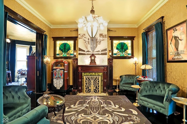 living area featuring ornamental molding, a notable chandelier, a tiled fireplace, and wallpapered walls