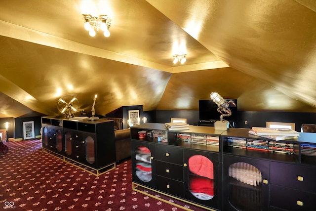 cinema featuring lofted ceiling and carpet flooring