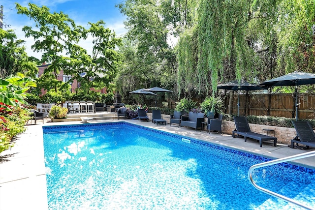 view of pool with a diving board, a patio area, fence, and a fenced in pool