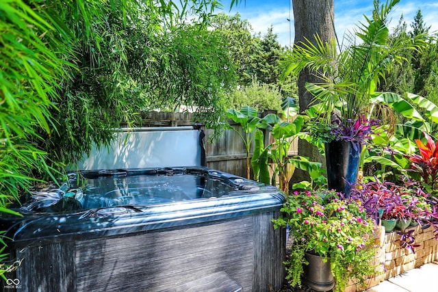 details featuring fence and a hot tub