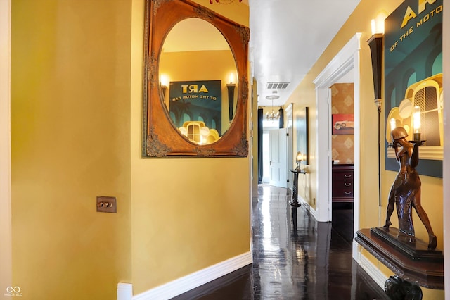 hall with marble finish floor, baseboards, and visible vents