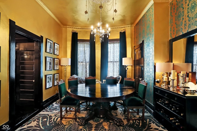 dining space with ornamental molding, a chandelier, and baseboards