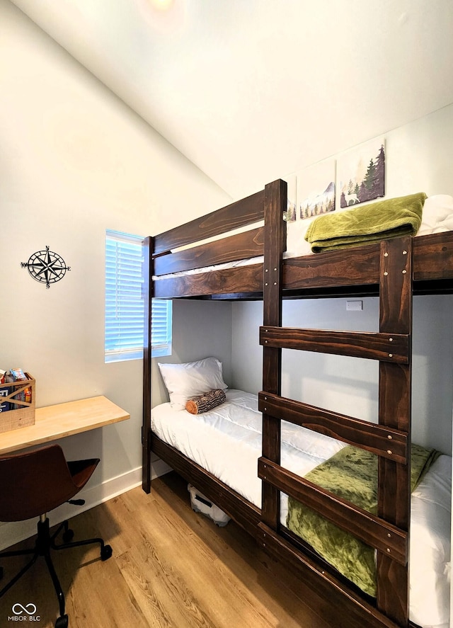 bedroom with baseboards and light wood-style floors