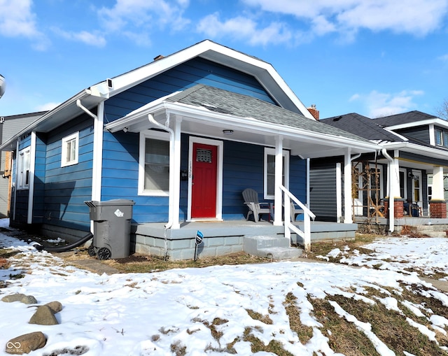 bungalow-style house featuring a porch and a shingled roof