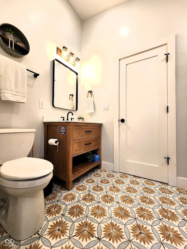 half bath featuring toilet, baseboards, and vanity