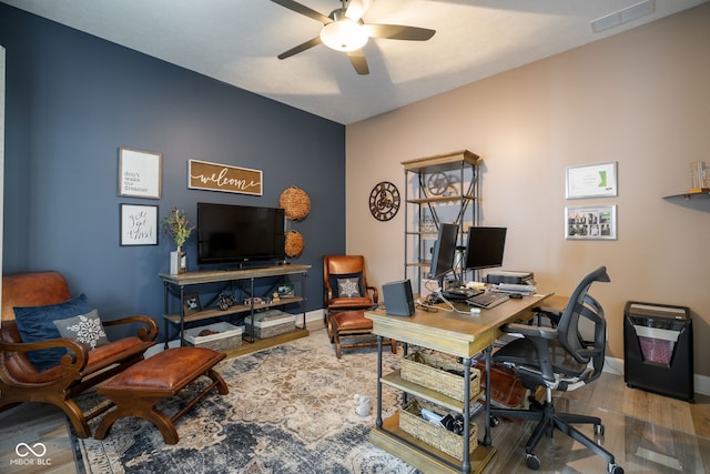 office space with ceiling fan, wood finished floors, visible vents, and baseboards