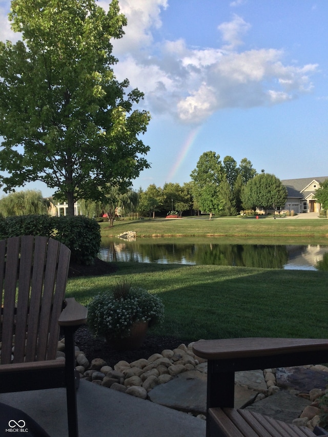 view of home's community featuring a water view and a yard