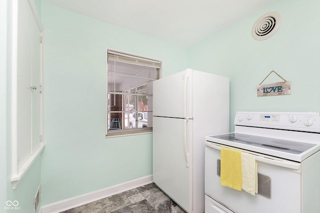 kitchen with white appliances, baseboards, visible vents, and stone finish flooring