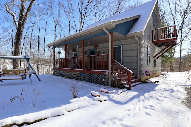 view of front of home featuring covered porch and a balcony