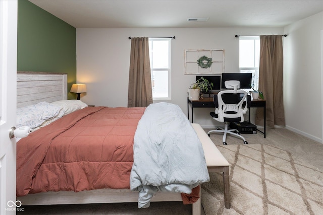 carpeted bedroom with visible vents and baseboards