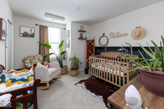 bedroom featuring attic access, carpet flooring, and visible vents