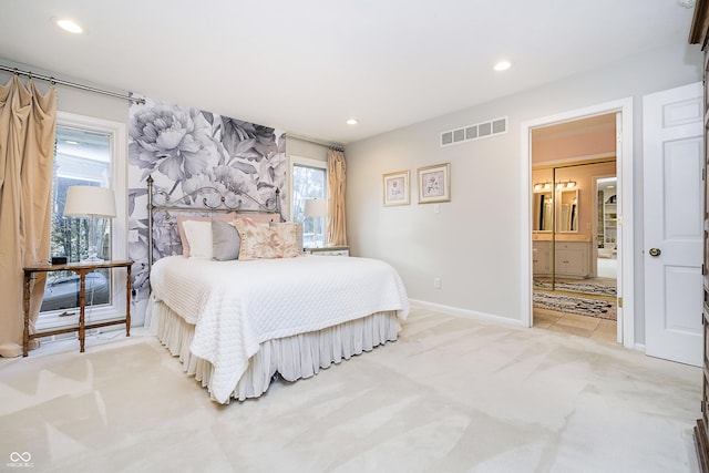 bedroom featuring connected bathroom, recessed lighting, light colored carpet, visible vents, and baseboards