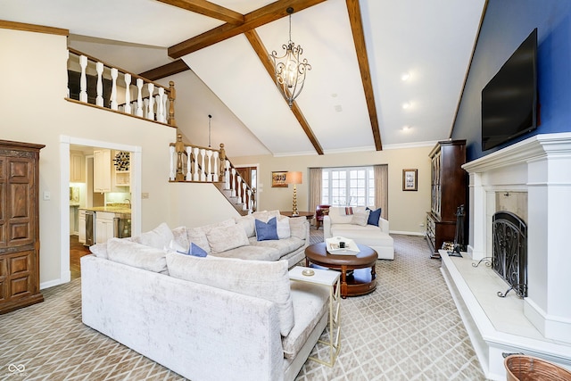 living area with high vaulted ceiling, beam ceiling, a fireplace with raised hearth, and stairs