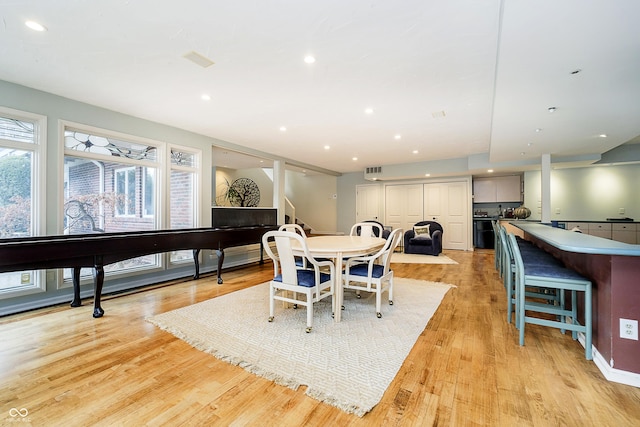 dining area featuring light wood-type flooring, a wealth of natural light, and recessed lighting