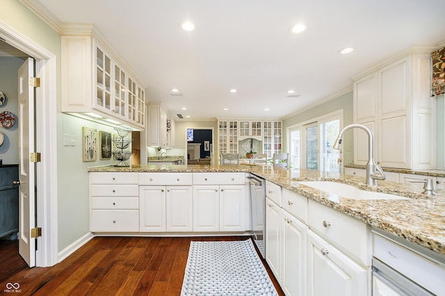 kitchen featuring white cabinetry, glass insert cabinets, dark wood finished floors, and a sink