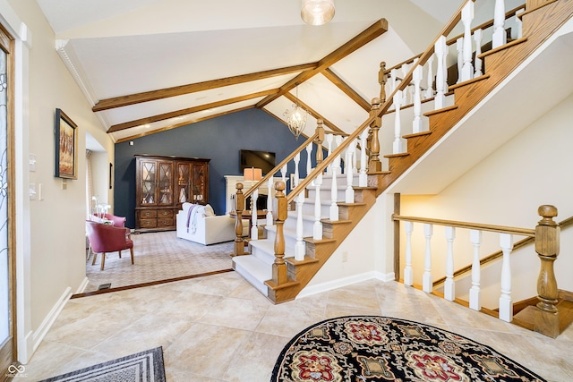 foyer entrance featuring lofted ceiling with beams, baseboards, stairway, and a notable chandelier