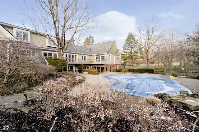 view of swimming pool with a patio area, a covered pool, and a deck