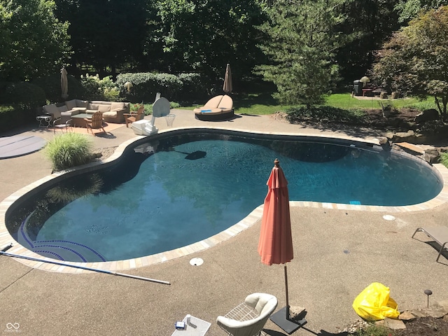 pool with an outdoor hangout area and a patio area