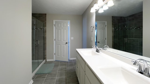 full bath with a sink, a stall shower, and tile patterned flooring