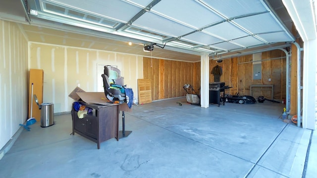 garage with electric panel and a garage door opener