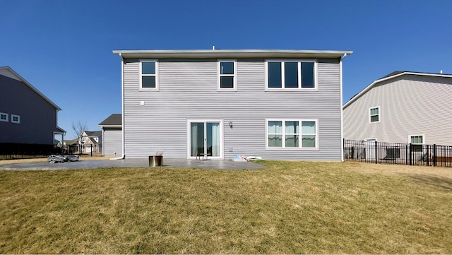 rear view of house with a patio area, a lawn, french doors, and fence