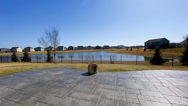 view of patio / terrace with a water view and a fenced backyard