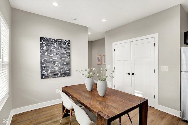 dining room featuring recessed lighting, baseboards, and wood finished floors