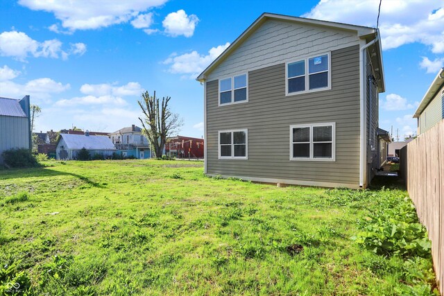 1624 Prospect St, Indianapolis, IN 46203 - rear view of property featuring a lawn and fence