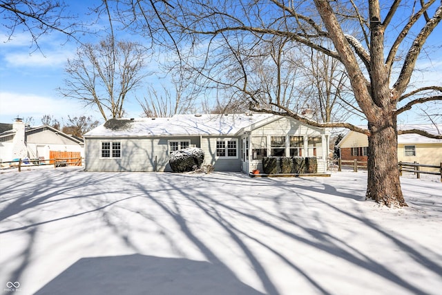 snow covered property featuring fence