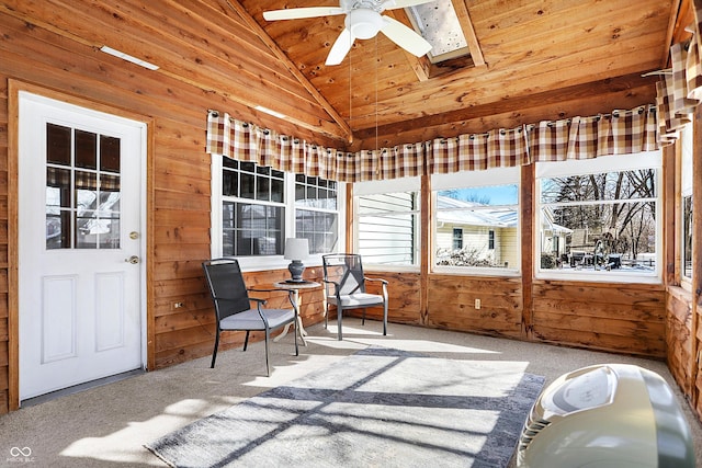 sunroom / solarium featuring wood ceiling, vaulted ceiling with skylight, and a ceiling fan