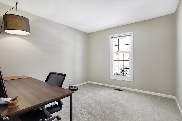 office with baseboards, visible vents, and light colored carpet