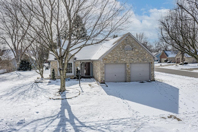 view of front of property featuring an attached garage and stone siding