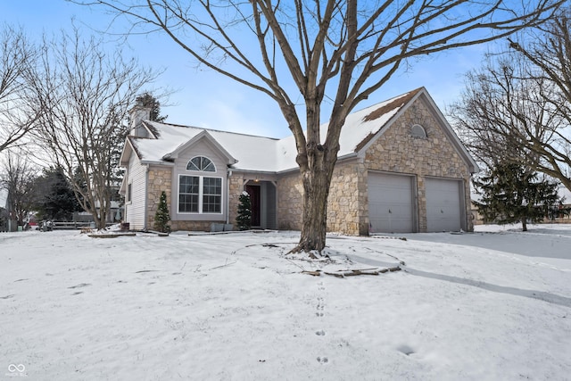 ranch-style home featuring stone siding, a chimney, and an attached garage