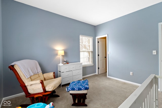 sitting room featuring baseboards and light colored carpet