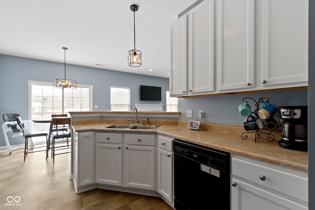 kitchen with pendant lighting, light countertops, white cabinetry, a sink, and dishwasher