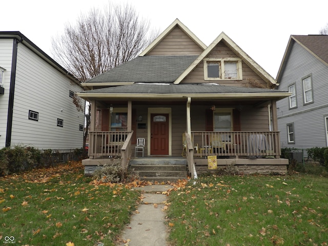 bungalow-style house with covered porch and a front yard