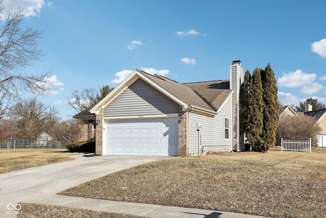 view of side of property featuring an attached garage, brick siding, fence, driveway, and a chimney