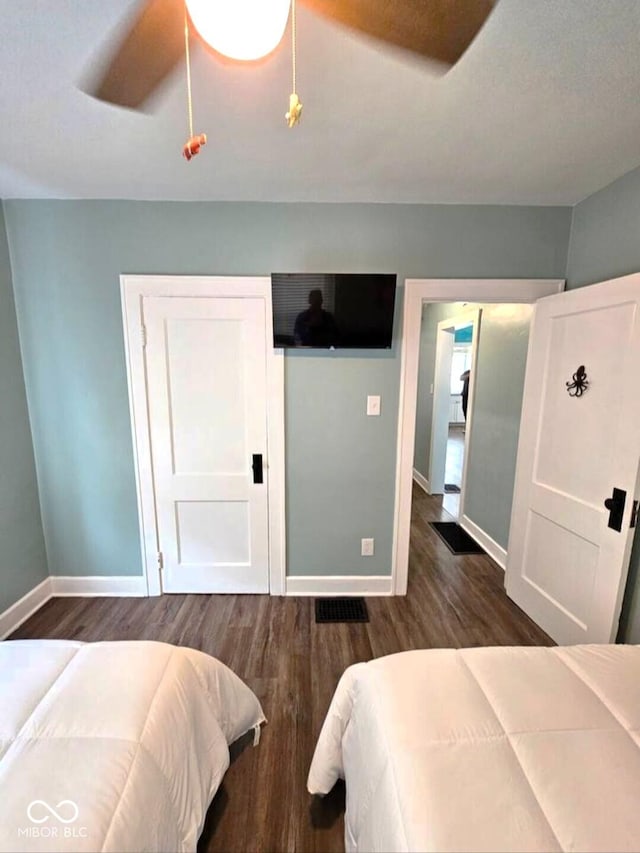 1046 Nelson Ave, Indianapolis, IN 46203 - bedroom with baseboards, ceiling fan, and dark wood-style flooring