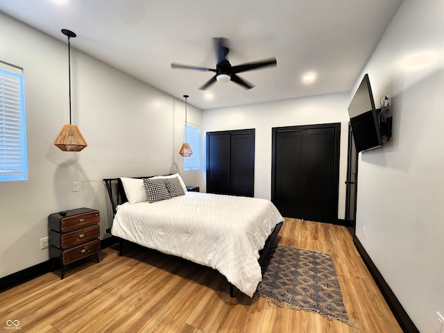 1046 Nelson Ave, Indianapolis, IN 46203 - bedroom featuring light wood-type flooring, baseboards, recessed lighting, ceiling fan, and two closets