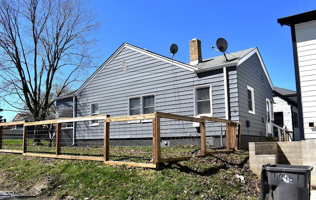 1046 Nelson Ave, Indianapolis, IN 46203 - rear view of property featuring a chimney and fence