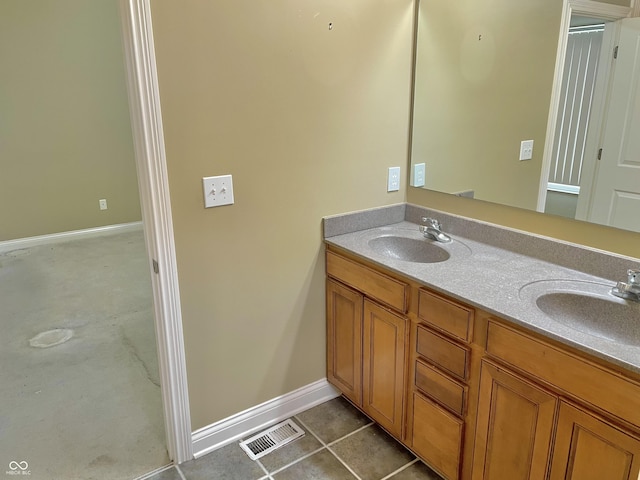 bathroom with double vanity, tile patterned flooring, visible vents, and a sink