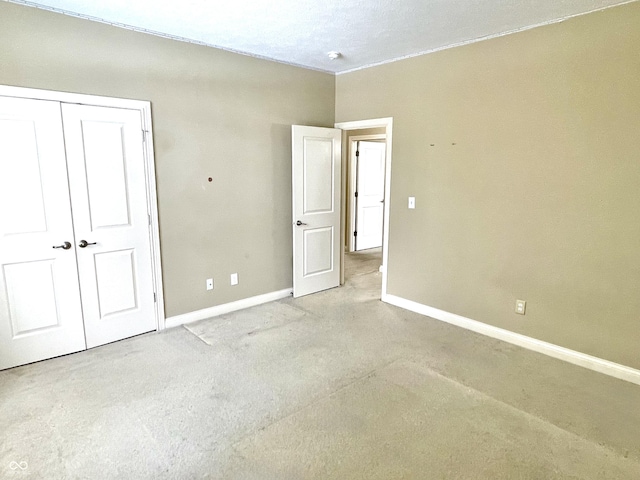 unfurnished bedroom featuring a closet and baseboards