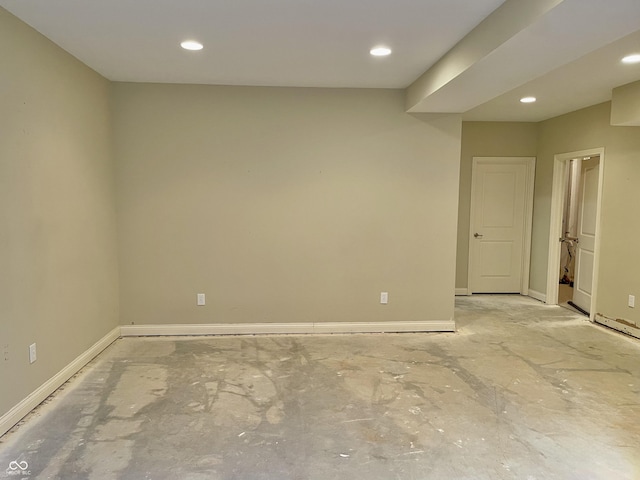 spare room featuring recessed lighting and baseboards