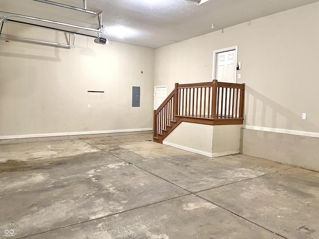 garage featuring a garage door opener and electric panel