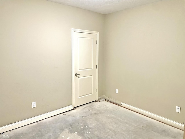 empty room featuring unfinished concrete flooring