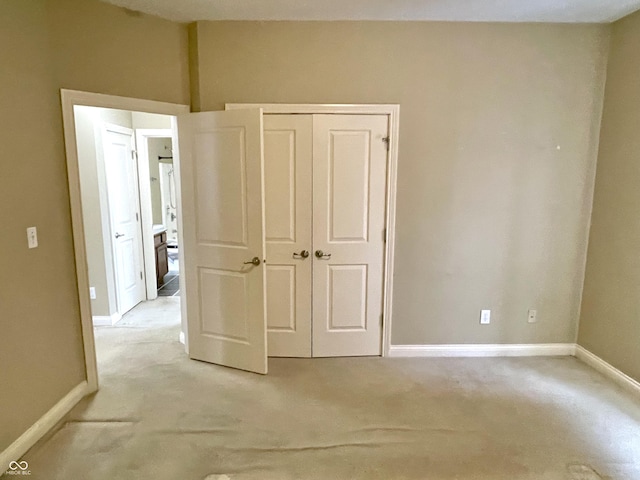 unfurnished bedroom featuring a closet and baseboards